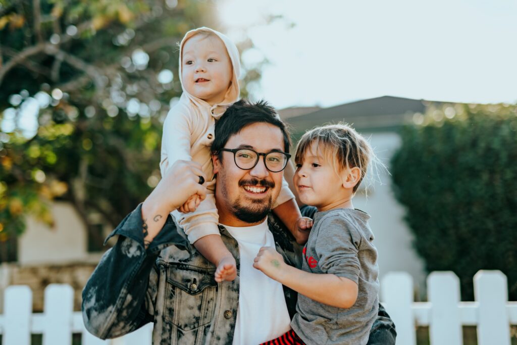 smiling man with his children